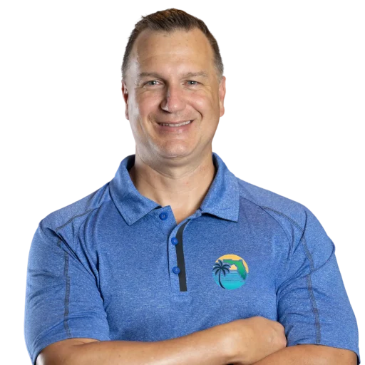 Ron, Florida real estate investor and cash home buyer, pictured with arms crossed wearing a blue company-branded shirt from Ron Buys Florida Homes.